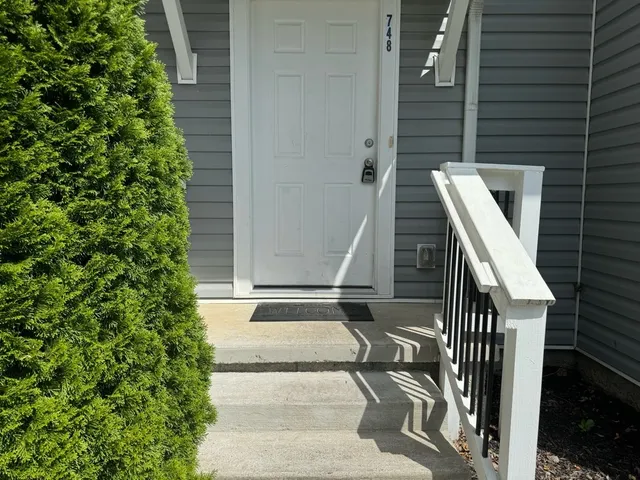 a view of entryway with wooden floor and fence