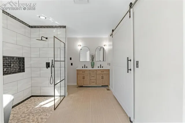 a bathroom with a double vanity sink mirror and shower