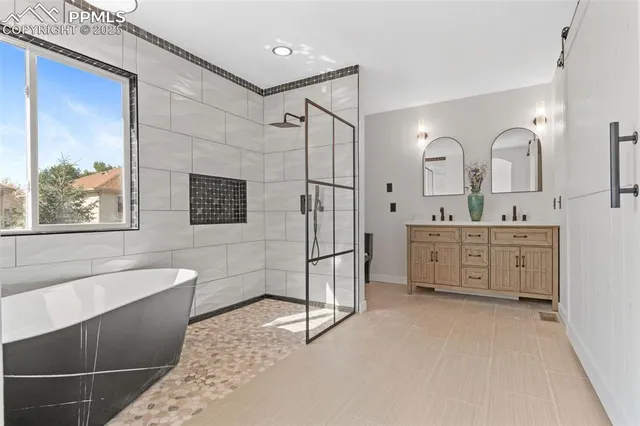 a spacious bathroom with a double vanity sink a mirror and a bathtub