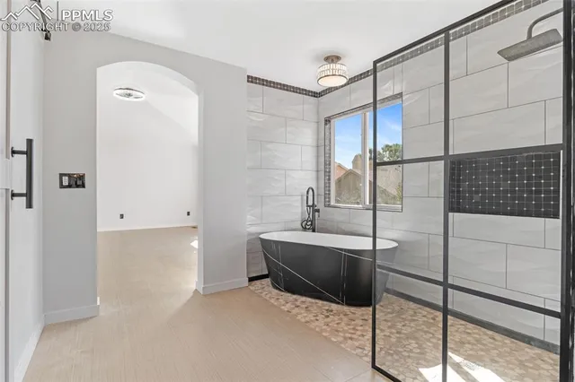 a bathroom with a tub and a shower