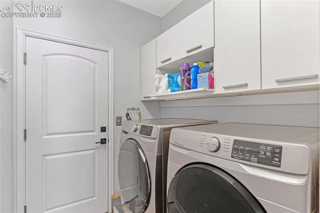 a bedroom with two beds and a flat screen tv