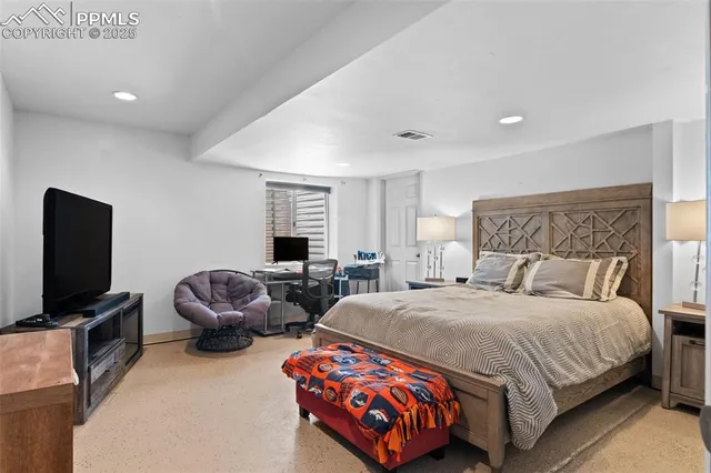 a bedroom with a bed and a couch