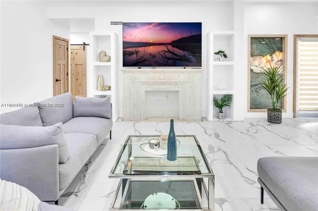 a living room with furniture a fireplace and a flat screen tv