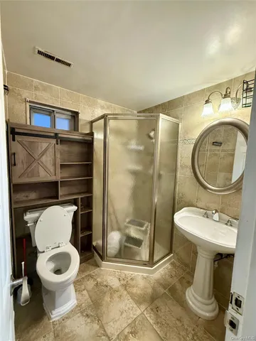 a bathroom with a toilet a sink and a shower