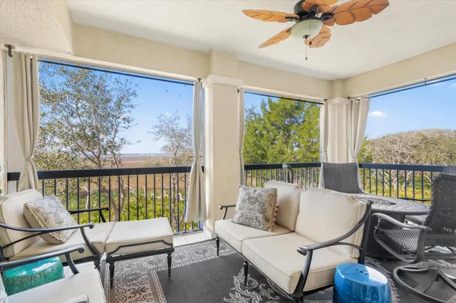 a view of a dining room with furniture a chandelier and wooden floor