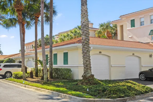 an aerial view of residential houses with outdoor space and seating