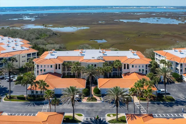 an aerial view of a house with outdoor space swimming pool and ocean view