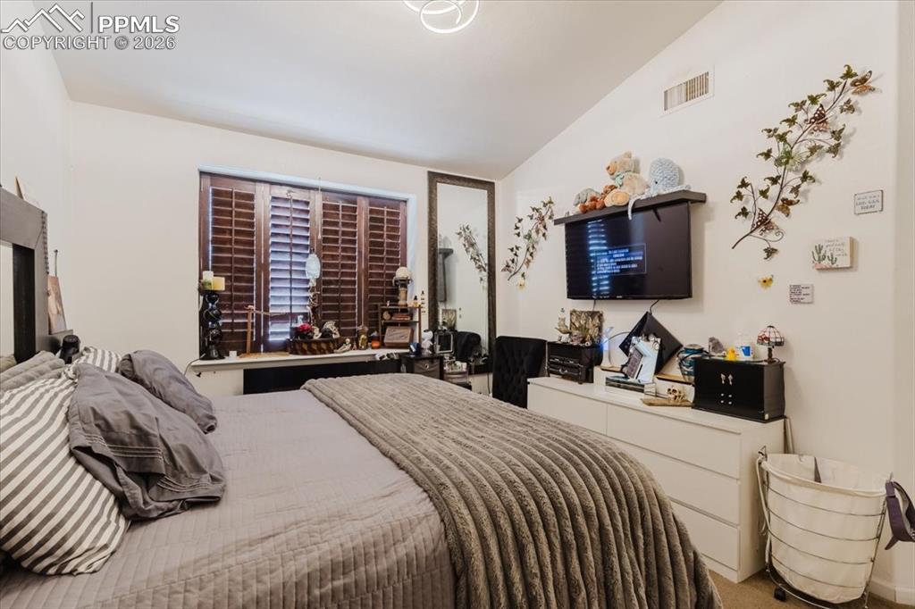 5800 Tower Road, Unit 108 Denver, CO 80249 - Photo 27 of 35 Room featuring a vaulted ceiling and a window with plantation shutters