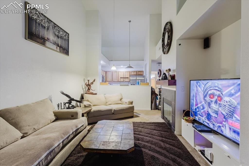 5800 Tower Road, Unit 108 Denver, CO 80249 - Photo 35 of 35 Living area with high ceilings, recessed lighting, and an integrated fireplace
