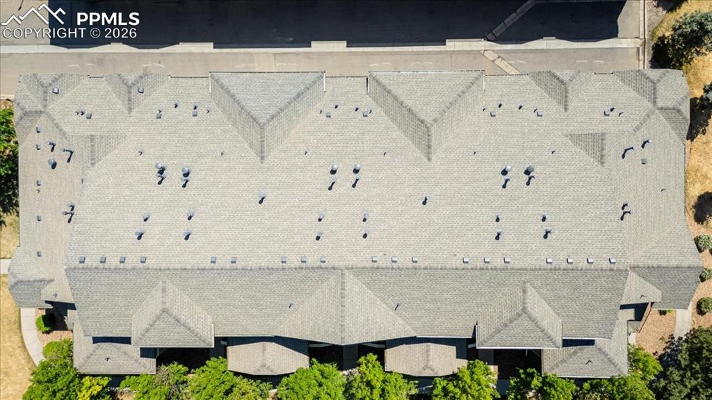 5800 Tower Road, Unit 108 Denver, CO 80249 - Photo 7 of 35 Shingled roofline featuring multiple gables and numerous ventilation units