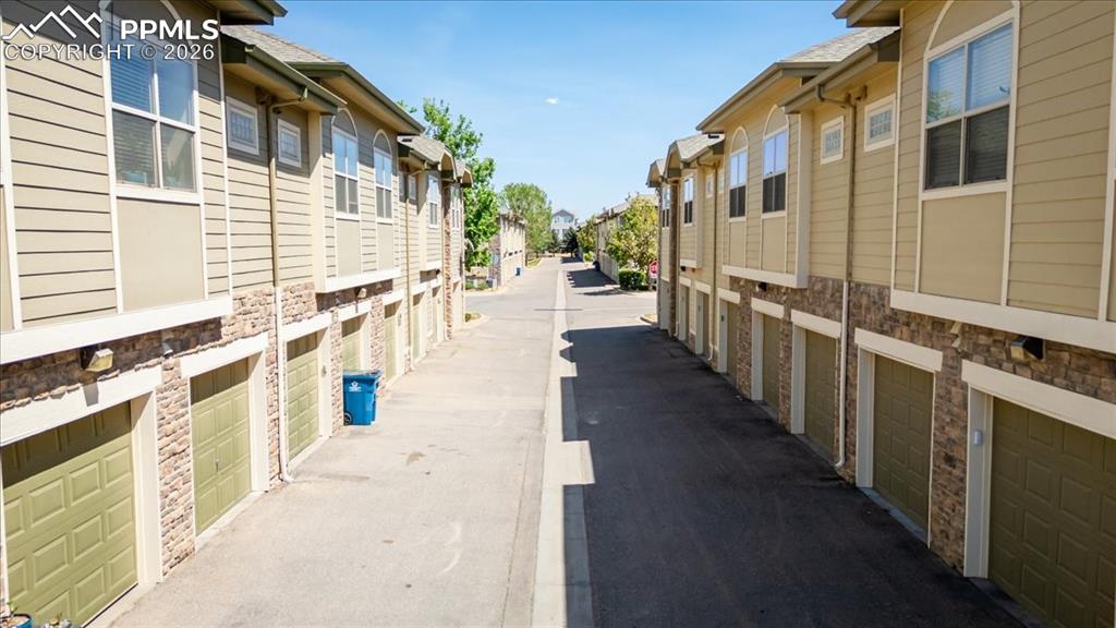 5800 Tower Road, Unit 108 Denver, CO 80249 - Photo 8 of 35 Row of residential units featuring individual garage access