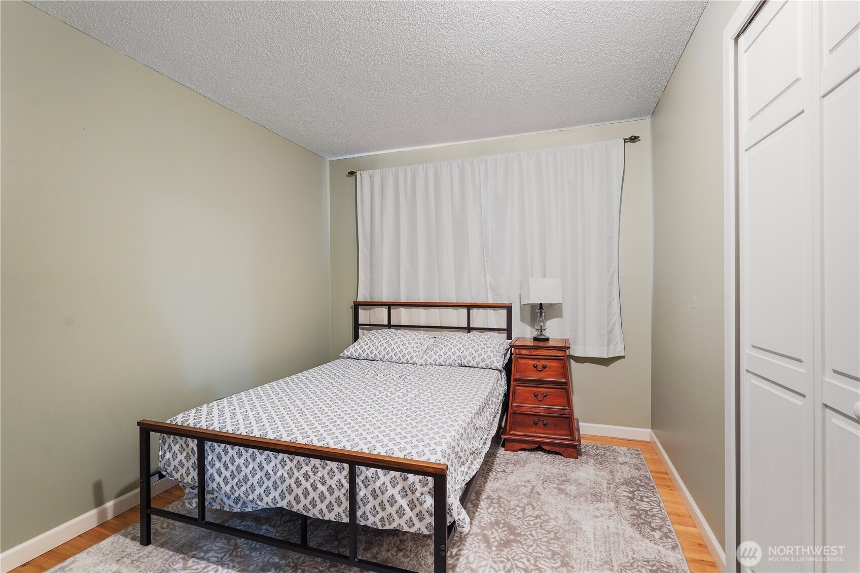 2120 Seaview Street West University Place, WA 98466 - Photo 24 of 33 a bedroom with a bed and wooden floor