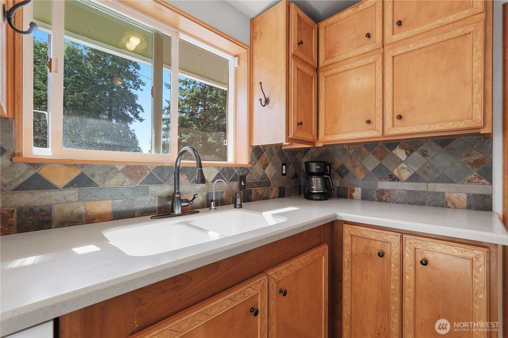 2120 Seaview Street West University Place, WA 98466 - Photo 6 of 33 a kitchen with stainless steel appliances granite countertop a sink and a cabinets next to a window