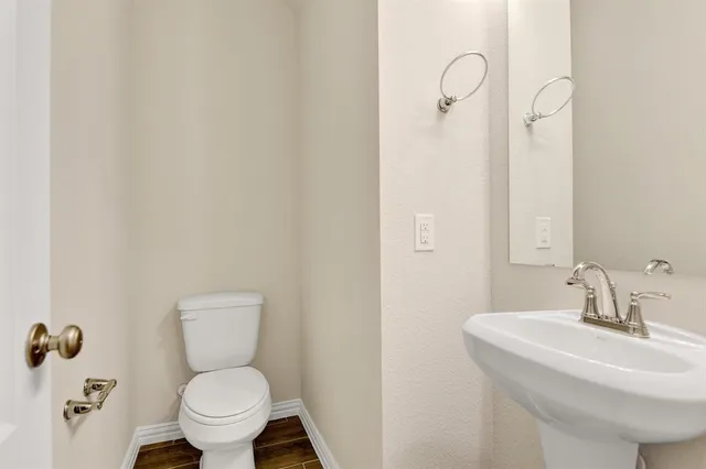 a kitchen with stainless steel appliances granite countertop a sink and cabinets with wooden floor
