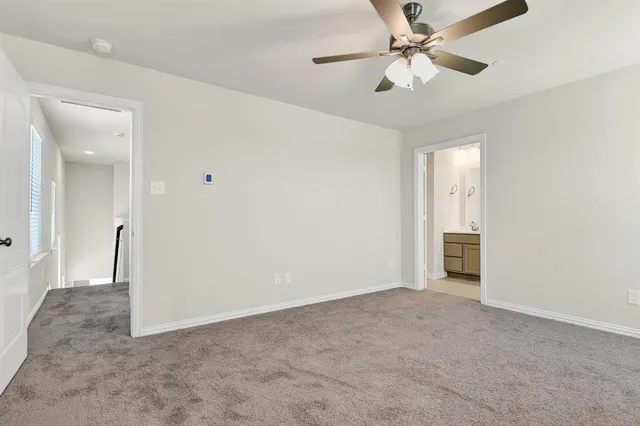 a view of an empty room and a ceiling fan