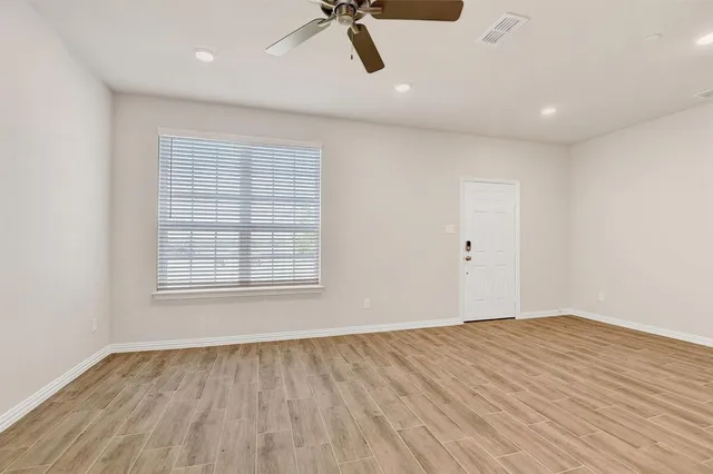 a view of a kitchen with a sink and wooden floor