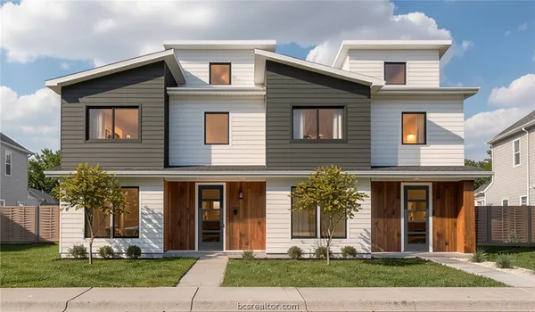 a front view of a house with garden and garage