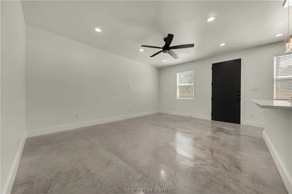 a view of an empty room with windows