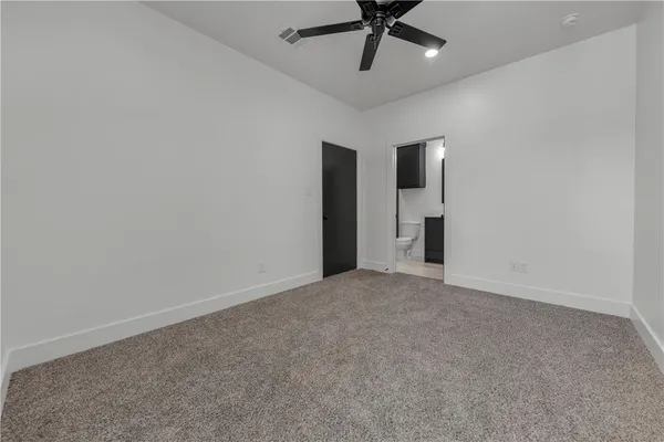 an empty room with a empty space and a ceiling fan