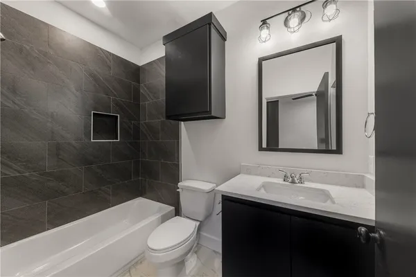 a bathroom with a sink toilet a mirror and shower