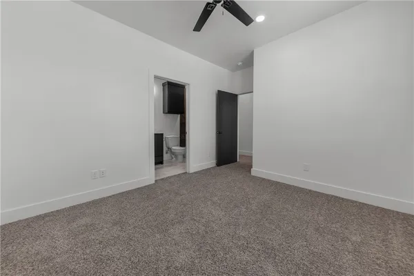 an empty room with chandelier fan