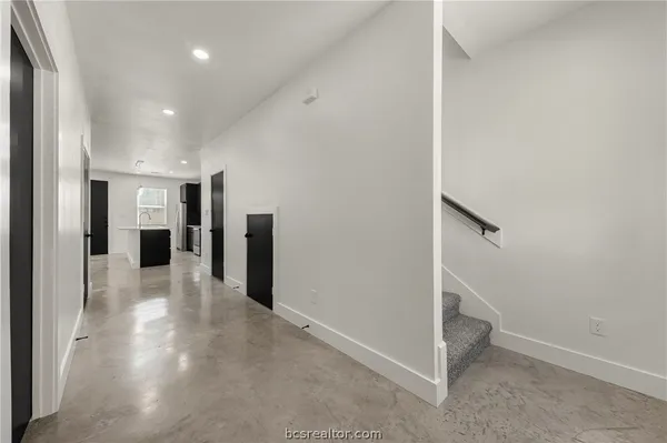 a view of a hallway with seating area