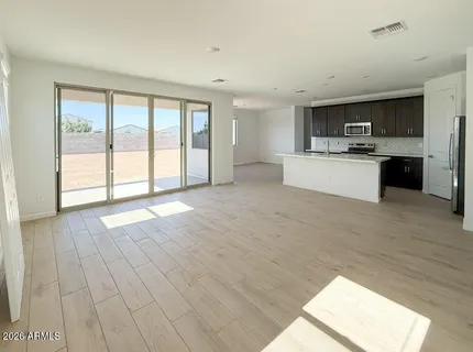 a large open kitchen with a sink and cabinets