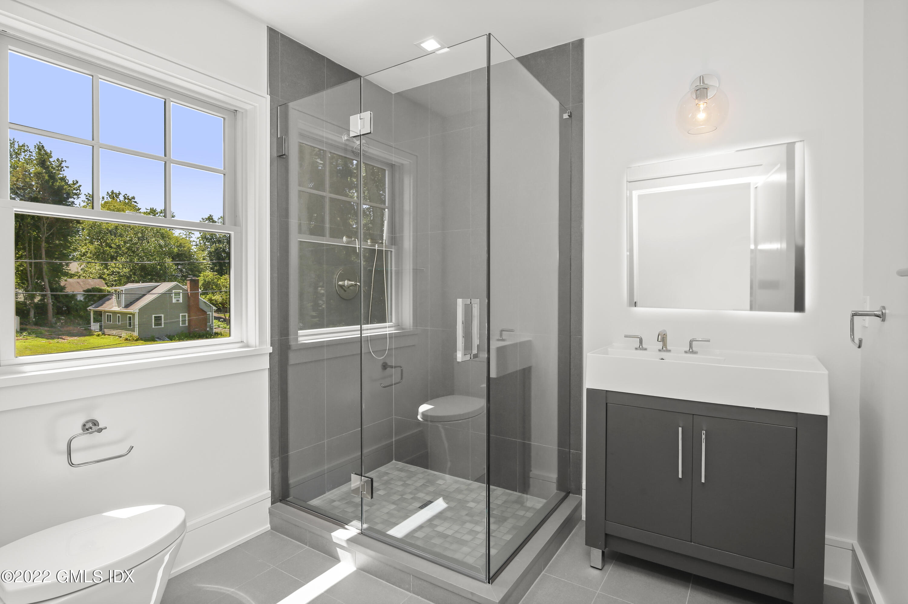 106 Sheep Hill Road Riverside, CT 06878 - Photo 36 of 53 a bathroom with a granite countertop sink a toilet a mirror and shower