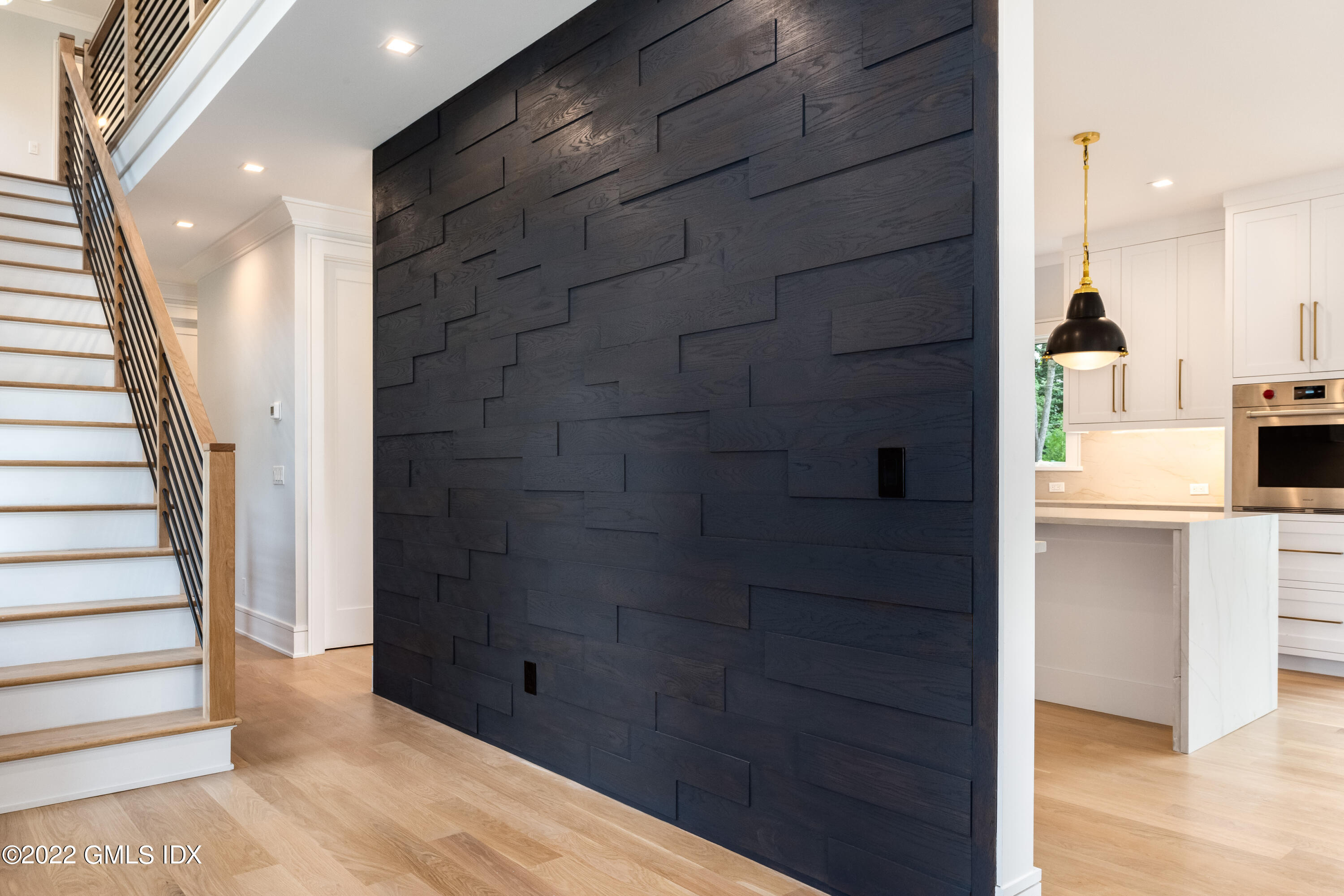 106 Sheep Hill Road Riverside, CT 06878 - Photo 9 of 53 a view of a hallway with wooden floor and staircase