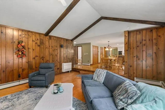 a view of a hallway with wooden floor and entryway
