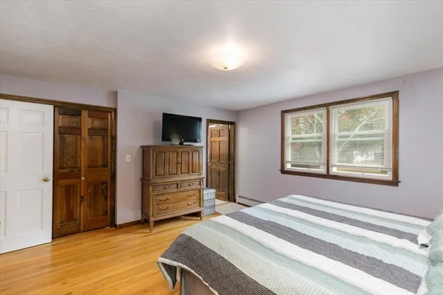 an aerial view of residential houses with outdoor space and trees