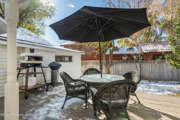 a patio with a patio table and chairs