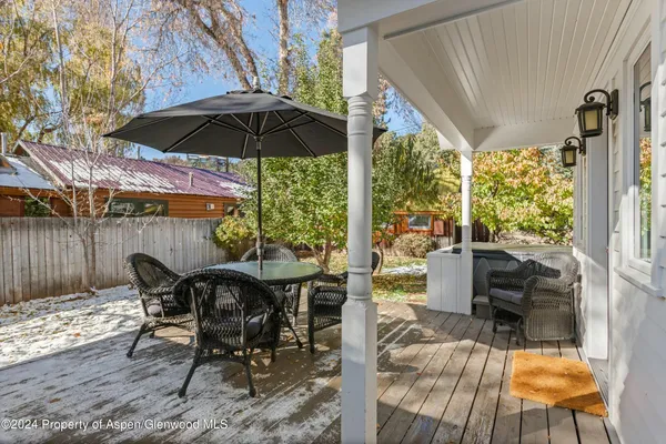 a view of an outdoor sitting area with furniture and umbrella