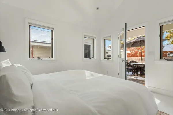 a large white bed in a white room