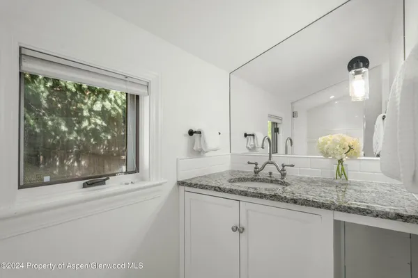 a bathroom with sinks granite and a vanity
