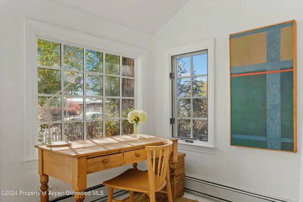 a dining room with a window and a table