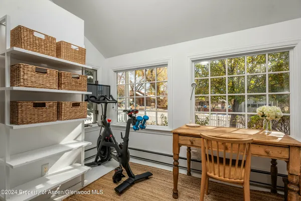 a work room with furniture and a window