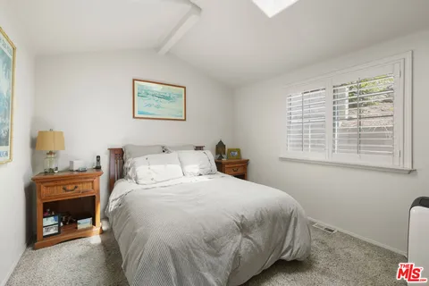 a bedroom with a bed and a lamp