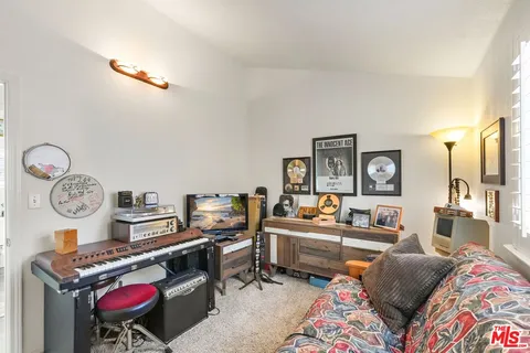 a living room with furniture a rug and a lamp