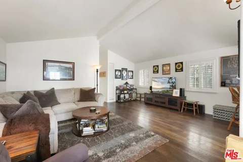 a living room with furniture or couch and a wooden floor