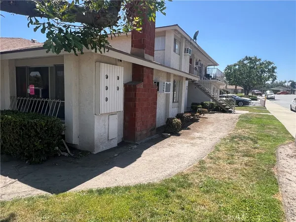 a backyard of a house with yard and outdoor seating
