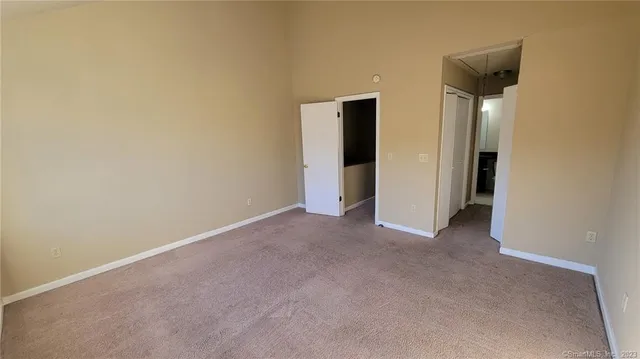 a view of an empty room with a cabinet