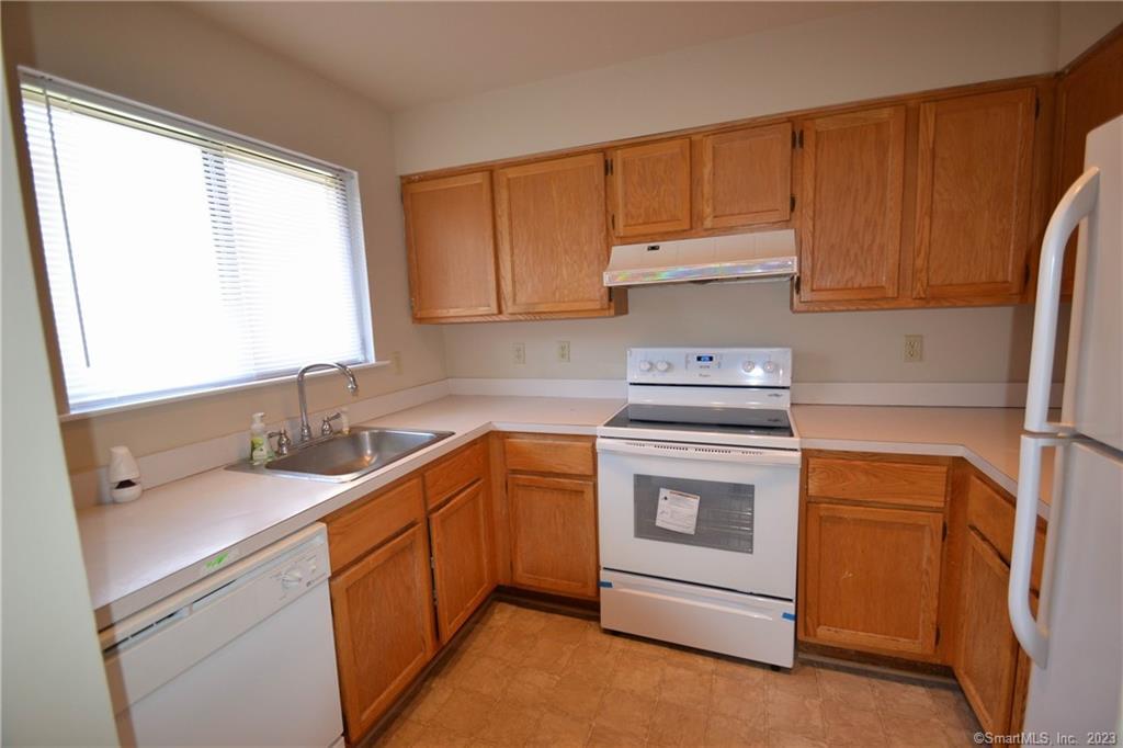 21 Deer Run, Unit 21 Bethel, CT 06801 - Photo 2 of 16 a kitchen with a sink stove and cabinets