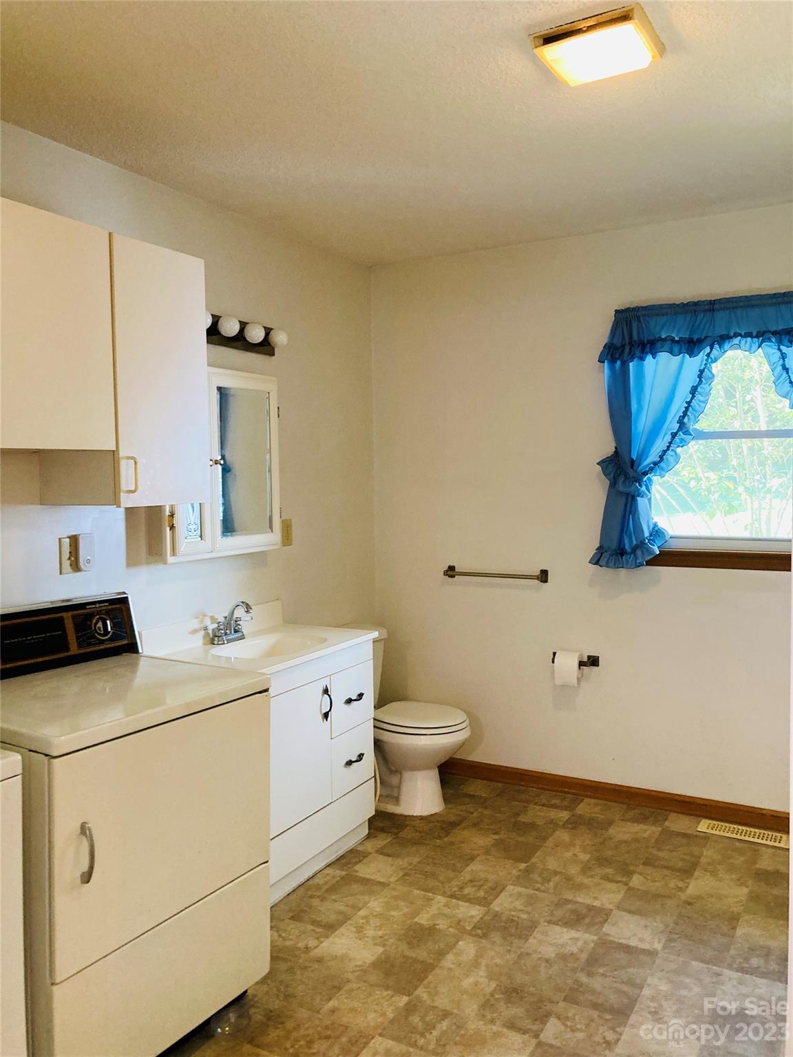 210 South Hillside Street Rutherfordton, NC 28139 - Photo 14 of 48 a bathroom with a sink a toilet and mirror