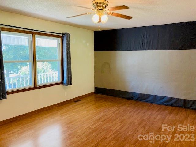 210 South Hillside Street Rutherfordton, NC 28139 - Photo 2 of 48 an empty room with wooden floor and windows
