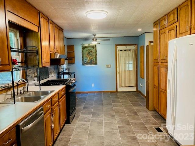 210 South Hillside Street Rutherfordton, NC 28139 - Photo 5 of 48 a kitchen with a sink a stove and a refrigerator