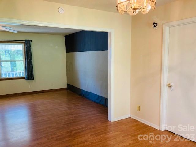 210 South Hillside Street Rutherfordton, NC 28139 - Photo 9 of 48 a view of an empty room with wooden floor and a window