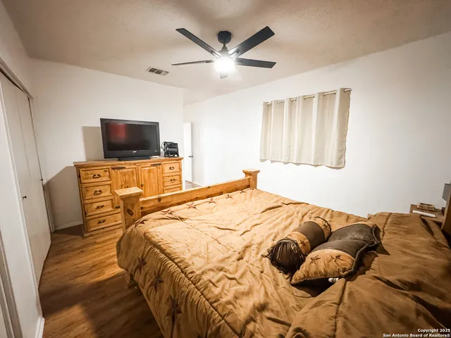 a bedroom with a bed and a flat screen tv