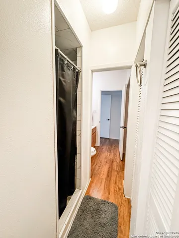 a view of hallway with wooden floor