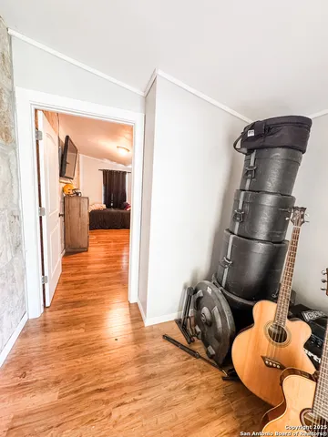 a kitchen with stainless steel appliances wooden floor and chair